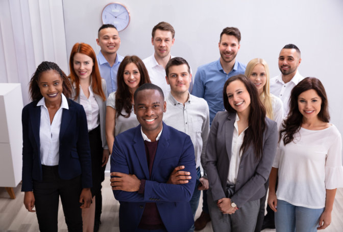 A group of professionals standing together in an office